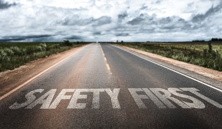Safety First written on rural road Safety First written on rural road